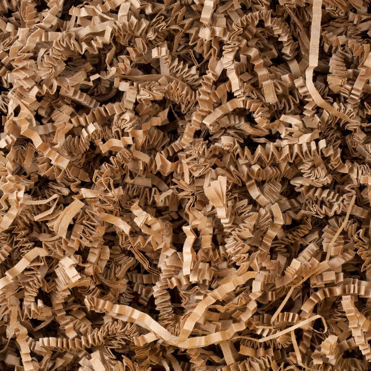 A close-up view of shredded brown kraft paper filler or crinkle packing material filling the frame.
