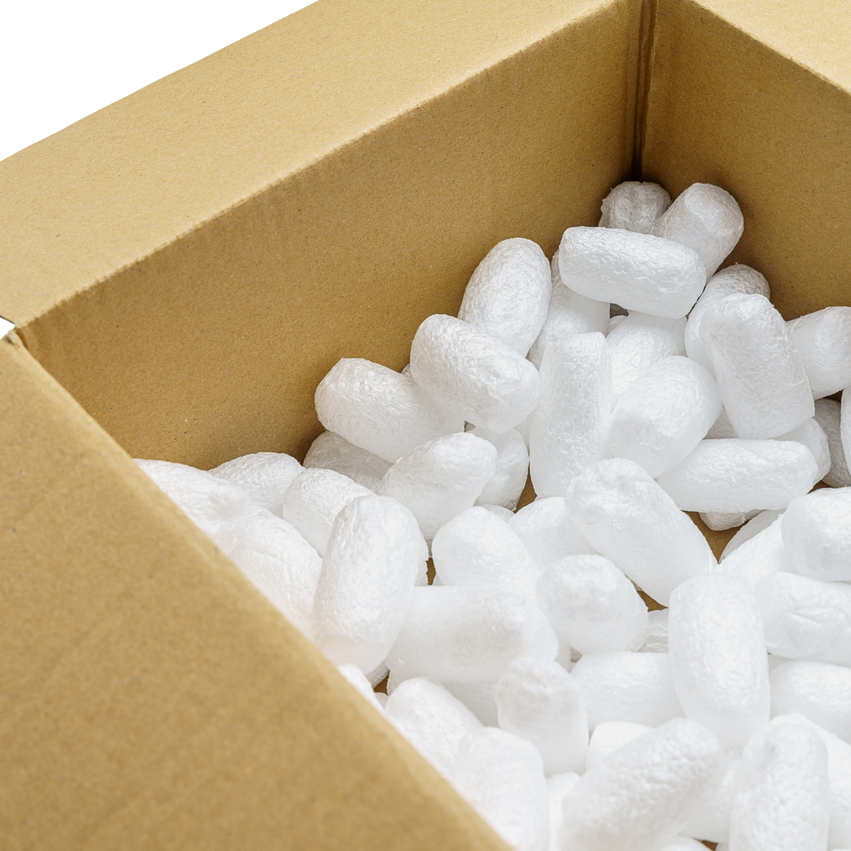 White packing peanuts filling the bottom of an open brown cardboard box.
